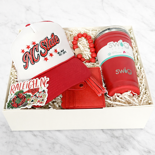NC State graduation gift box with Swig tumbler, trucker hat, card holder wristlet and Raleigh sticker