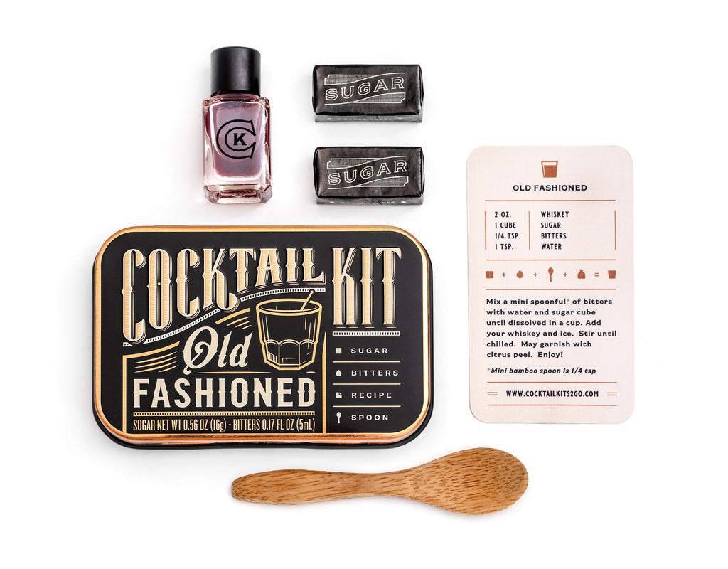 Quiet Luxury gift box open with sage green ribbon showing cocktail bar spoon and infused orange wheels