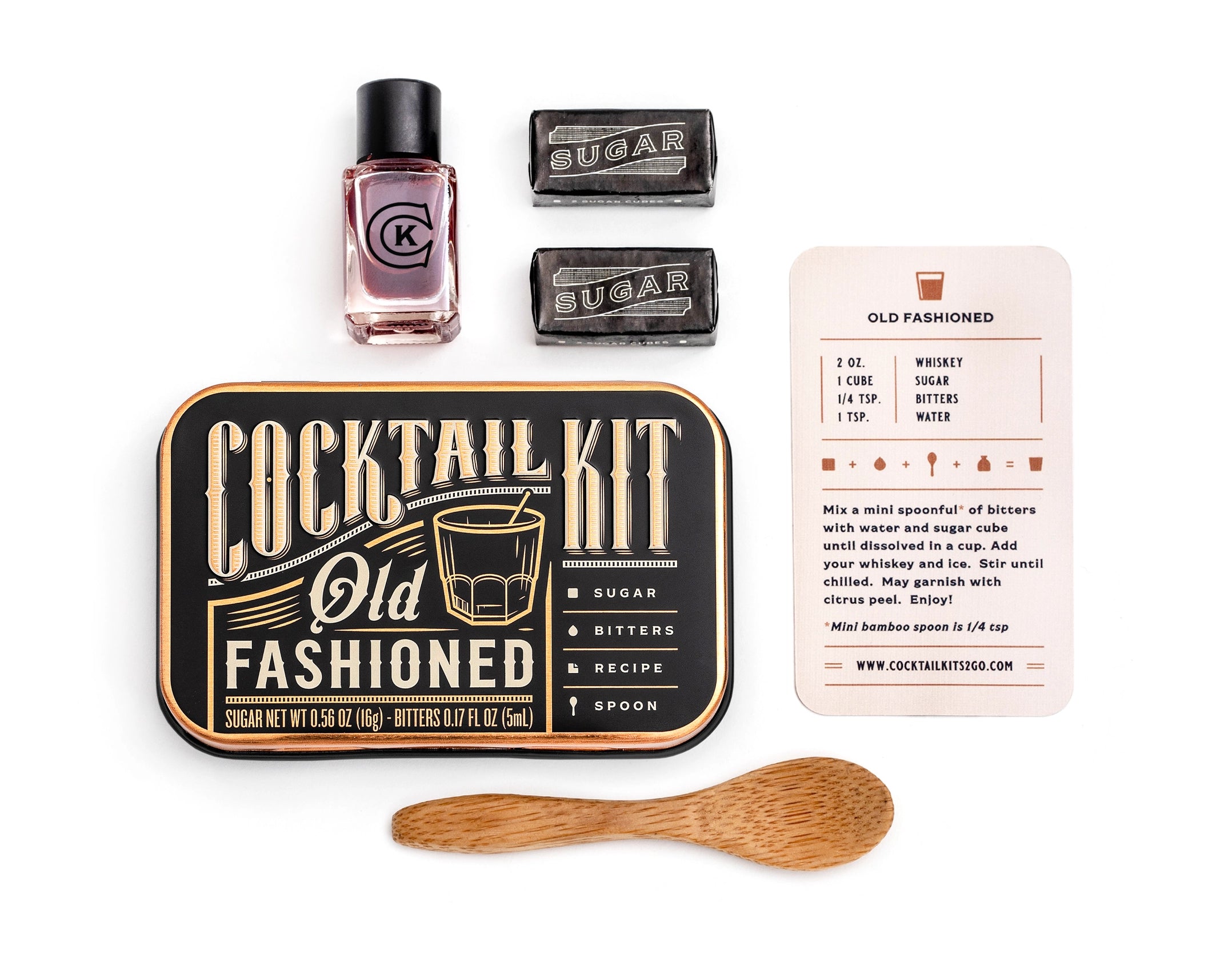 Quiet Luxury gift box open with sage green ribbon showing cocktail bar spoon and infused orange wheels